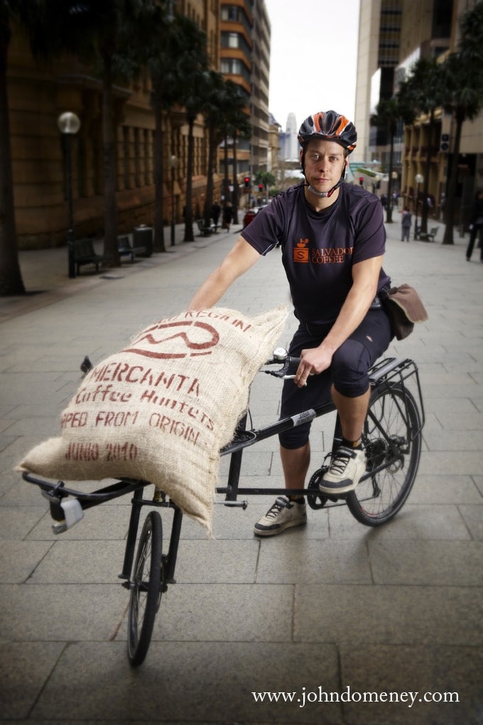 Cycle messenger delivering coffee
