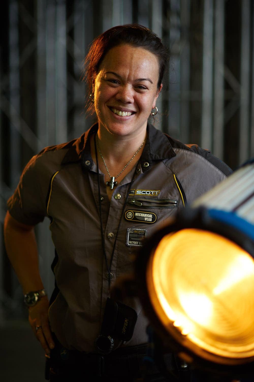 Female lighting technician with a film light Women in non traditional occupations Rigger